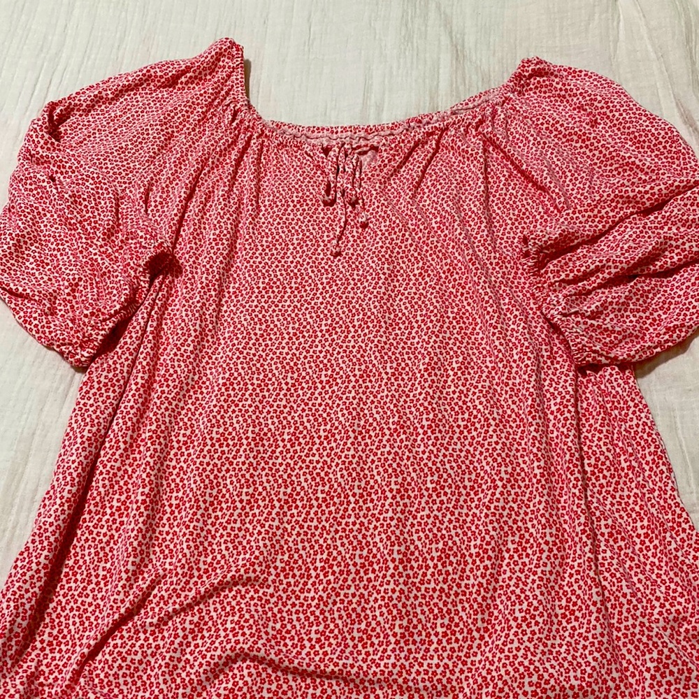 White shirt with pink/red flowers;